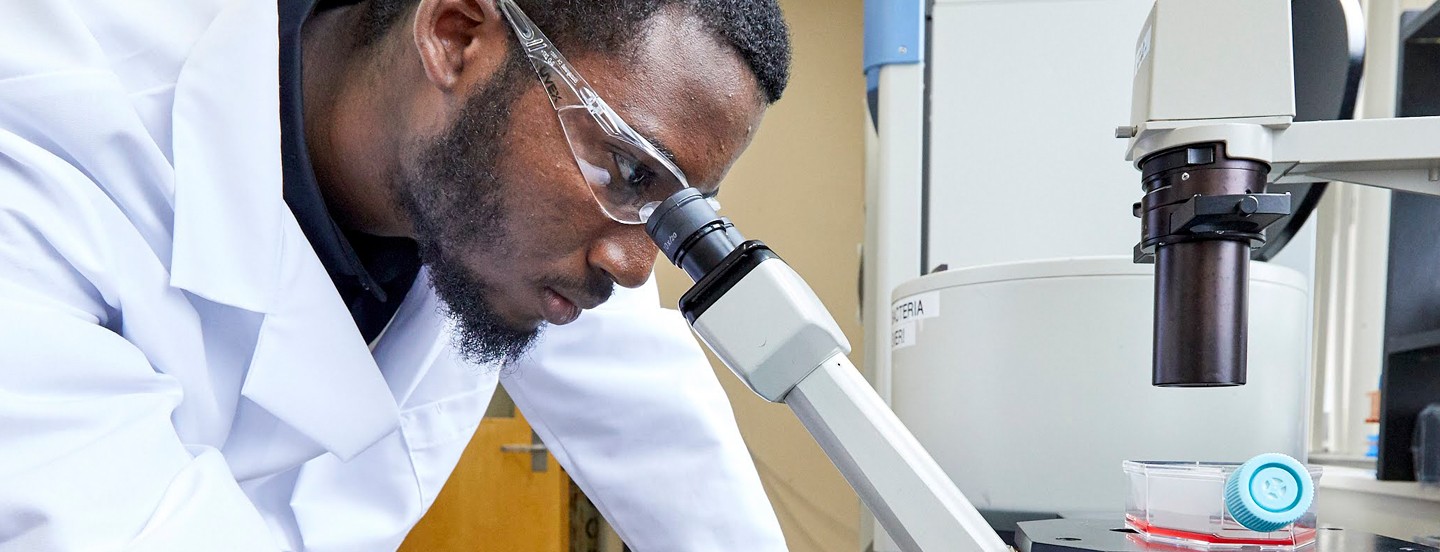 Student Looking Through Microscope
