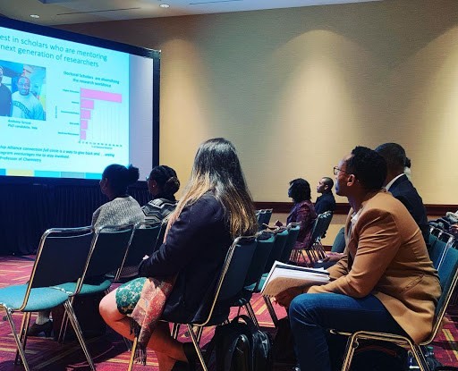 Group of people watching presentation at a conference