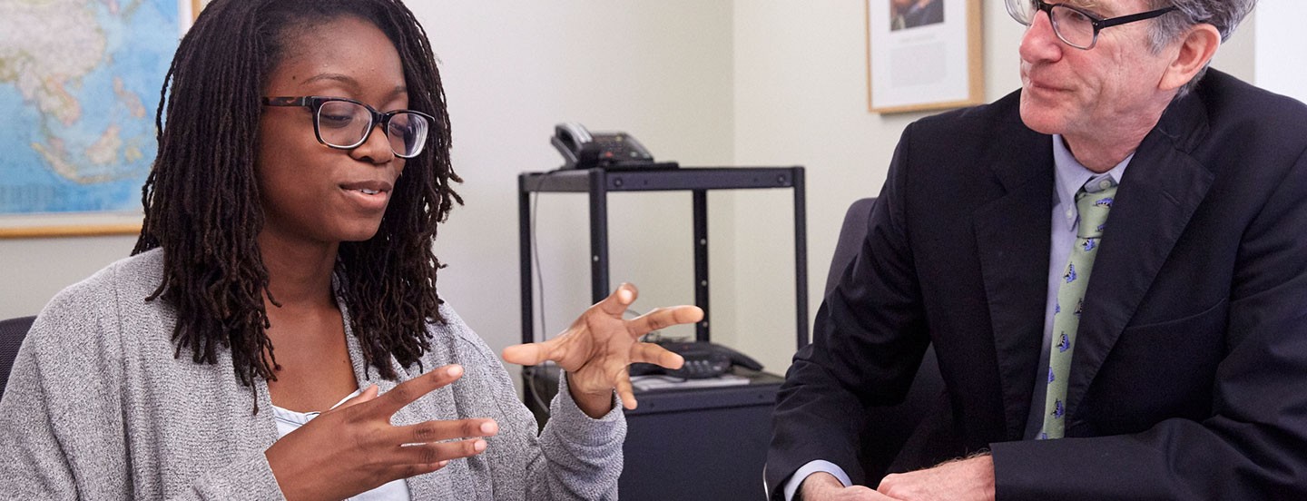 young student and professor in an interview discussing the work