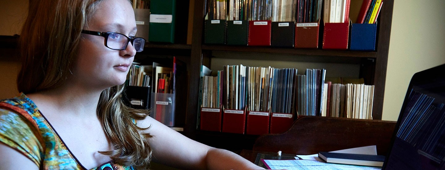 young student working on a laptop in library