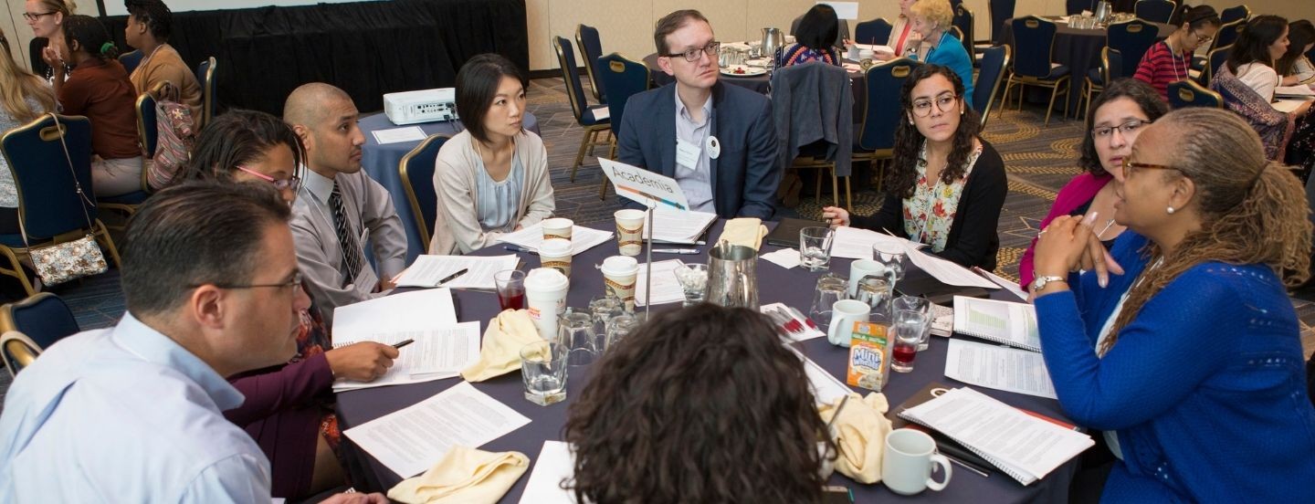 group of people in at table talking