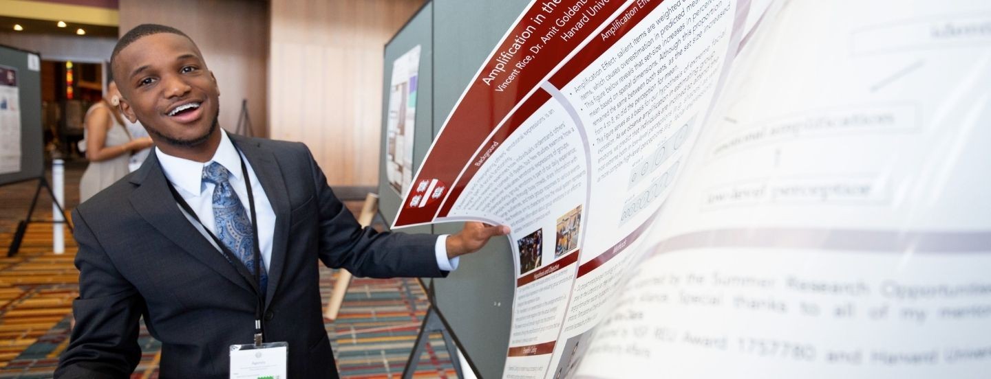 student smiling at poster