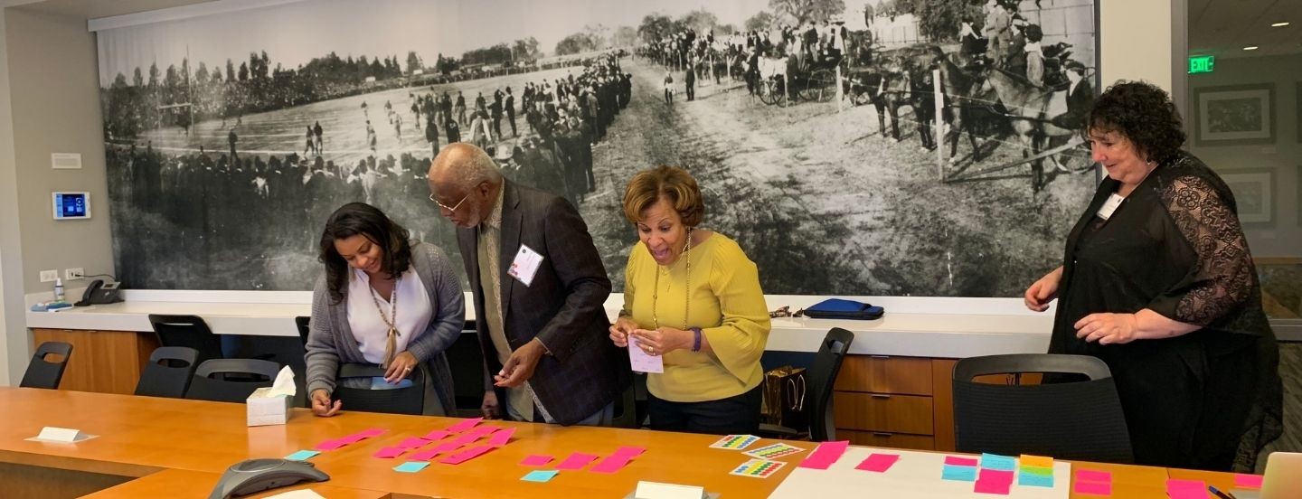 group of people looking at notes on table