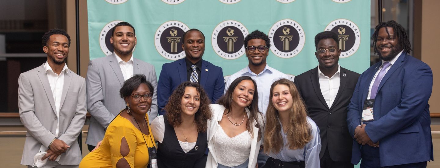 students in front of running banner