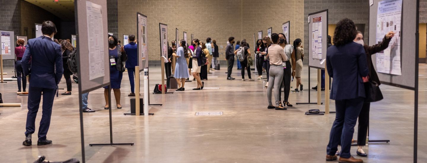 exhibit hall with students presenting posters