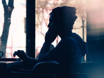 man working in cafe at a laptop